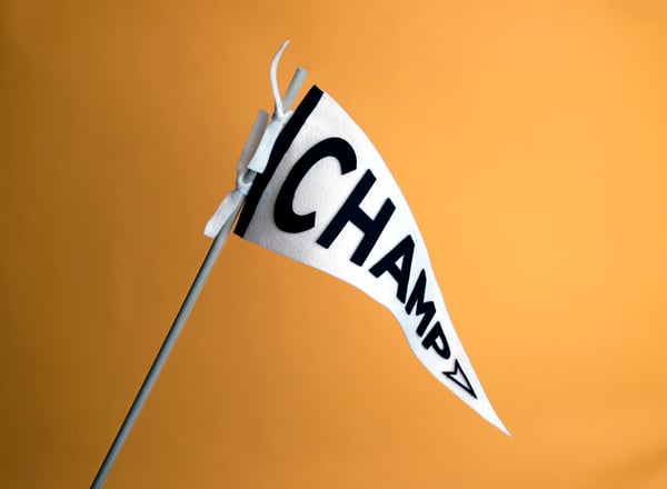 A triangular flag with "Champ" spelled on it