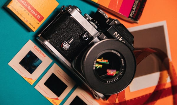 Image of an old Nikon camera on a brightly colored background