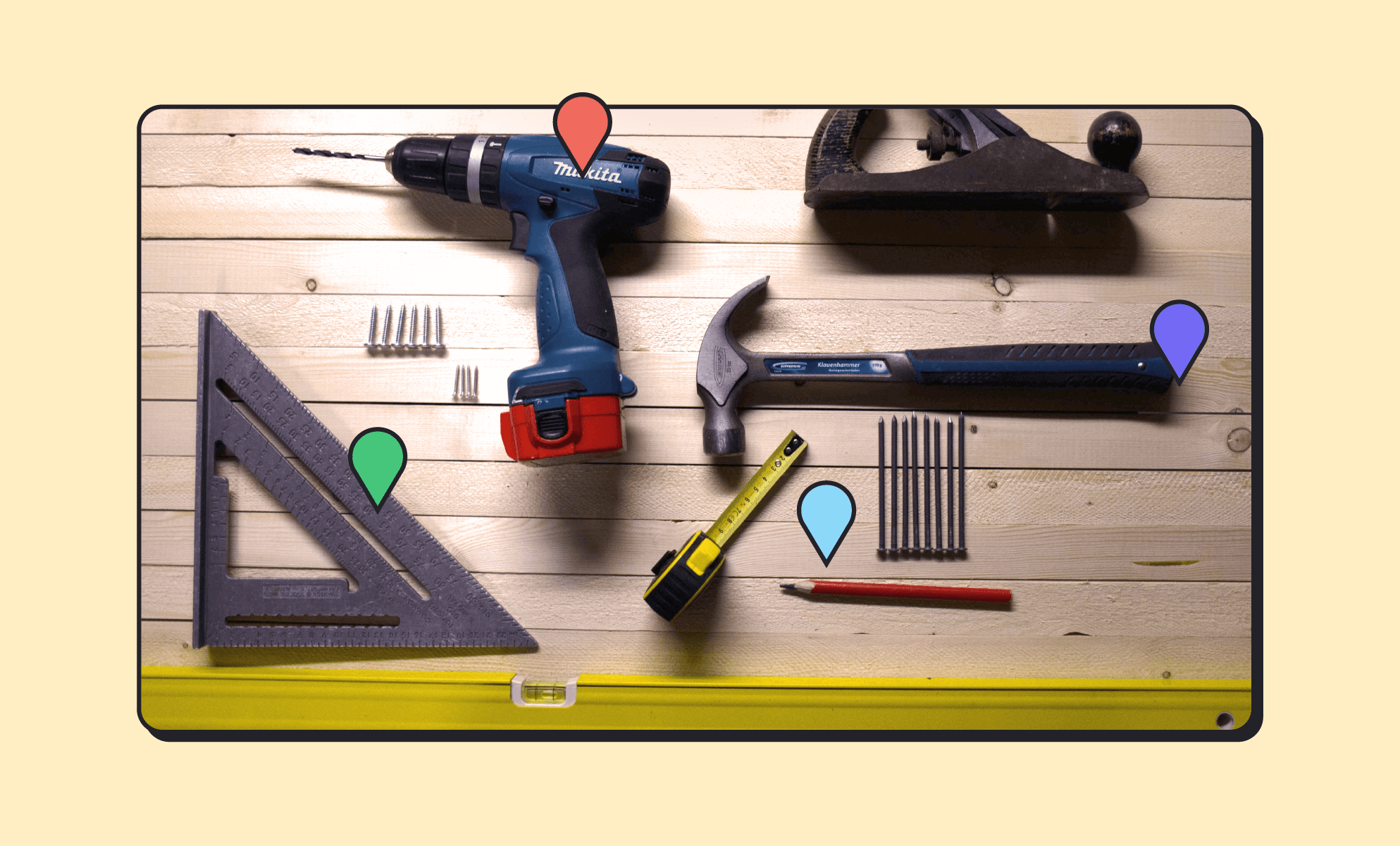 Construction and power tools on a wood table, including a Mikita drill, ruler, planer, hammer, tape measure, pencil, and drill bits. (BrainStorm, Inc. - Oct. 2021)